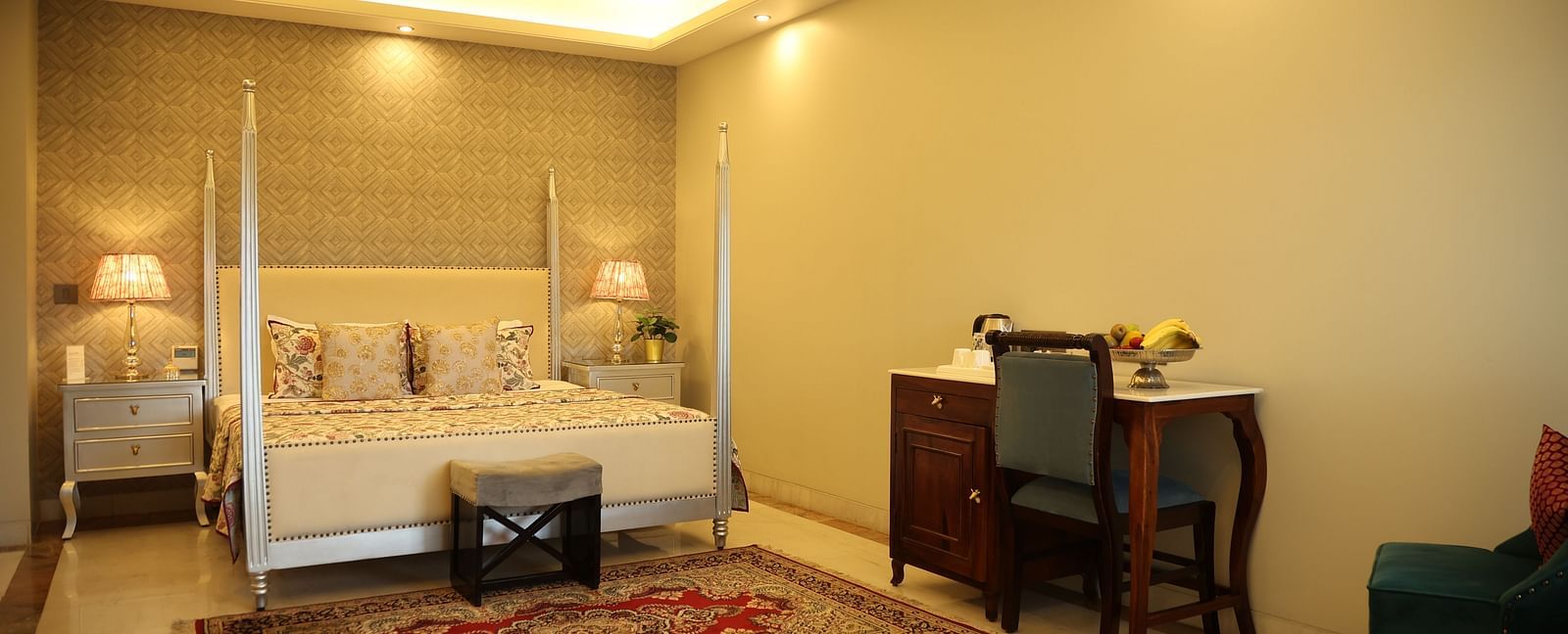 A room at Dileep Kothi, Jaipur with a double bed and a work desk and chair